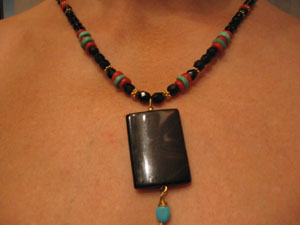 14. Necklace of Onyx, Coral, Turquoise and 24 karat Gold beads with drop of Onyx and Turquoise