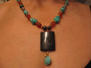 15. Necklace of Onyx, Carnelian, Turquoise and 24 karat Gold beads with drop of Onyx and Turquoise